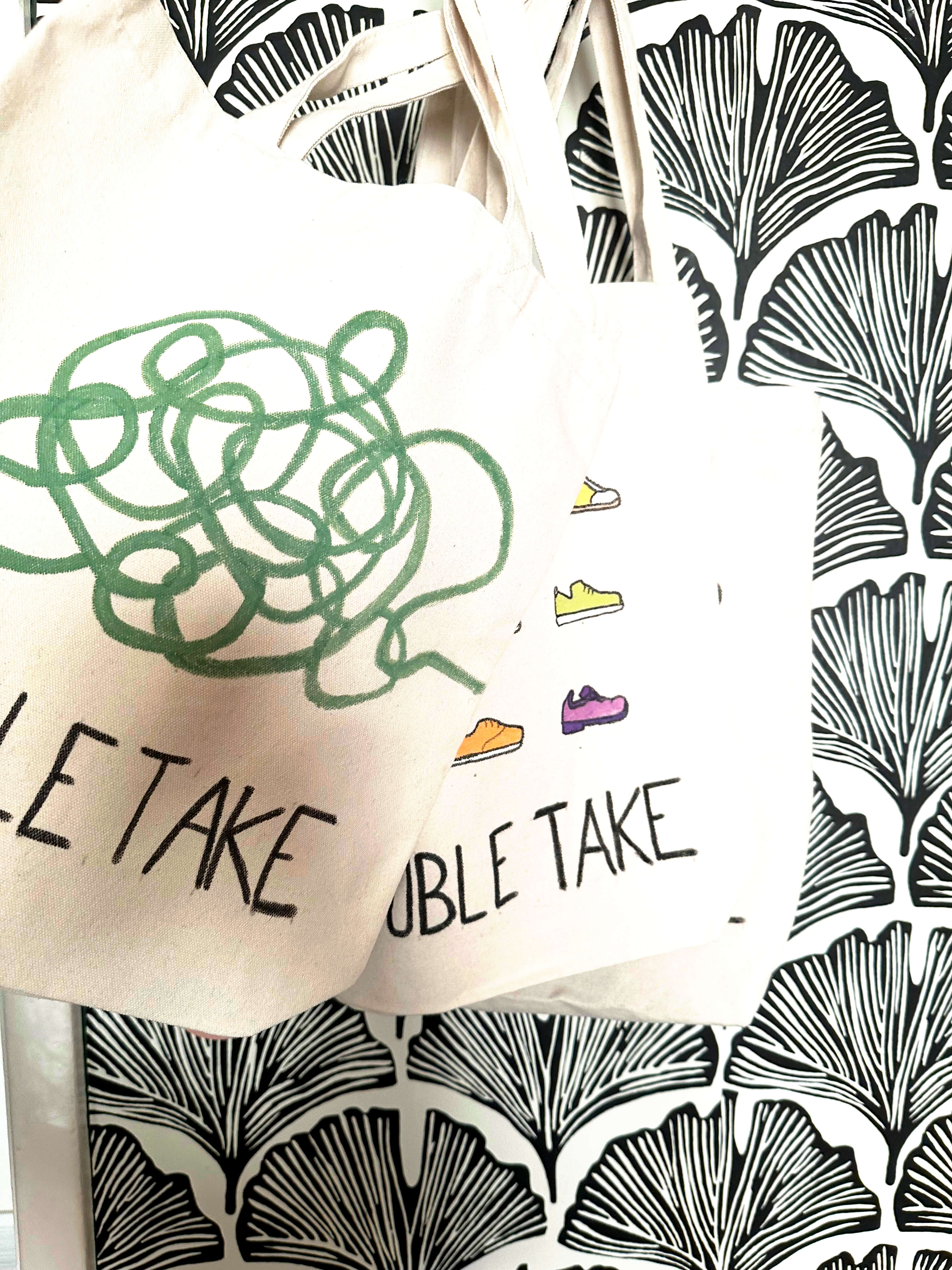 Tote bags with positive, motivational phrases and images on them. 