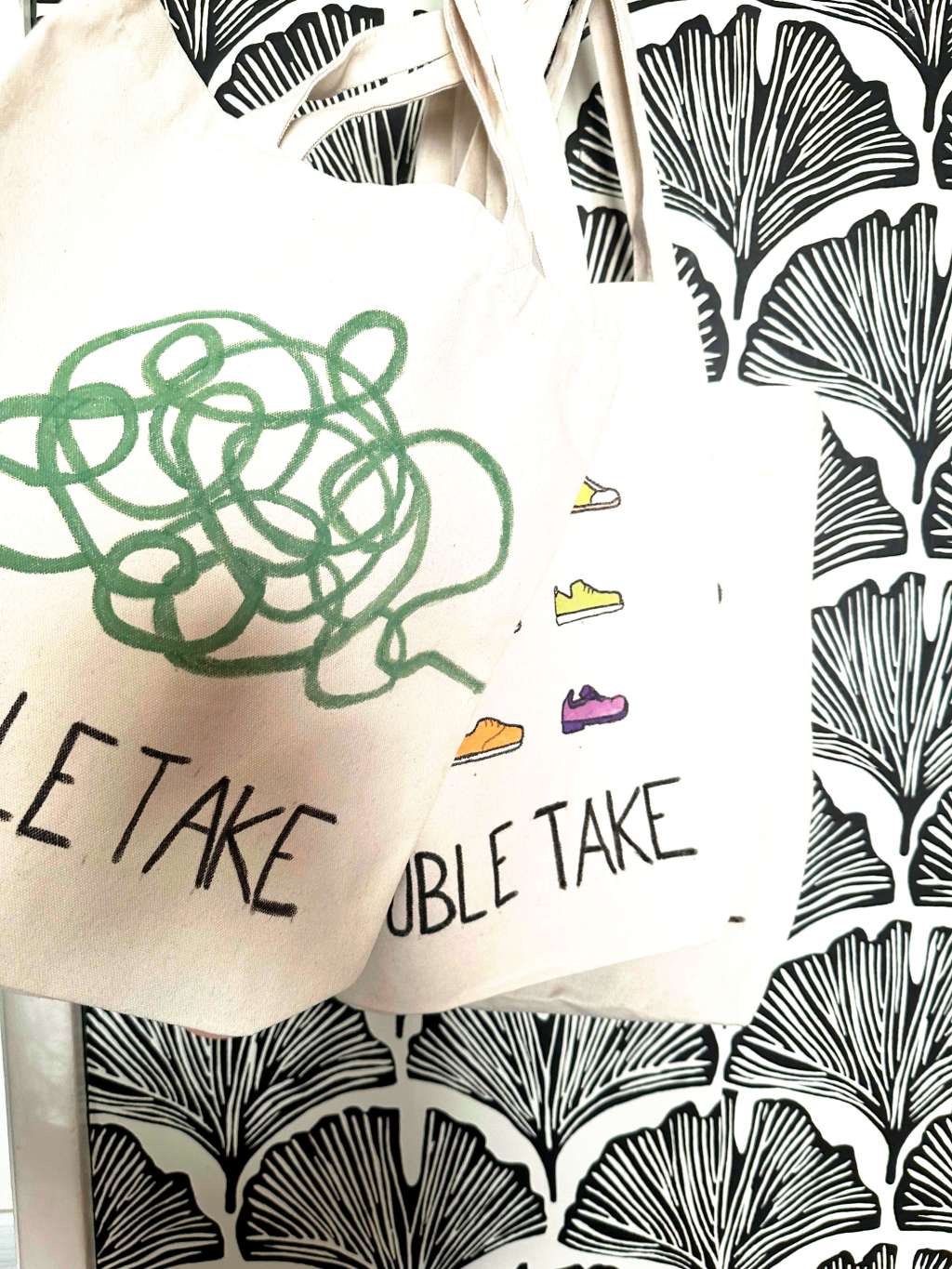 Tote bags with positive, motivational phrases and images on them.
