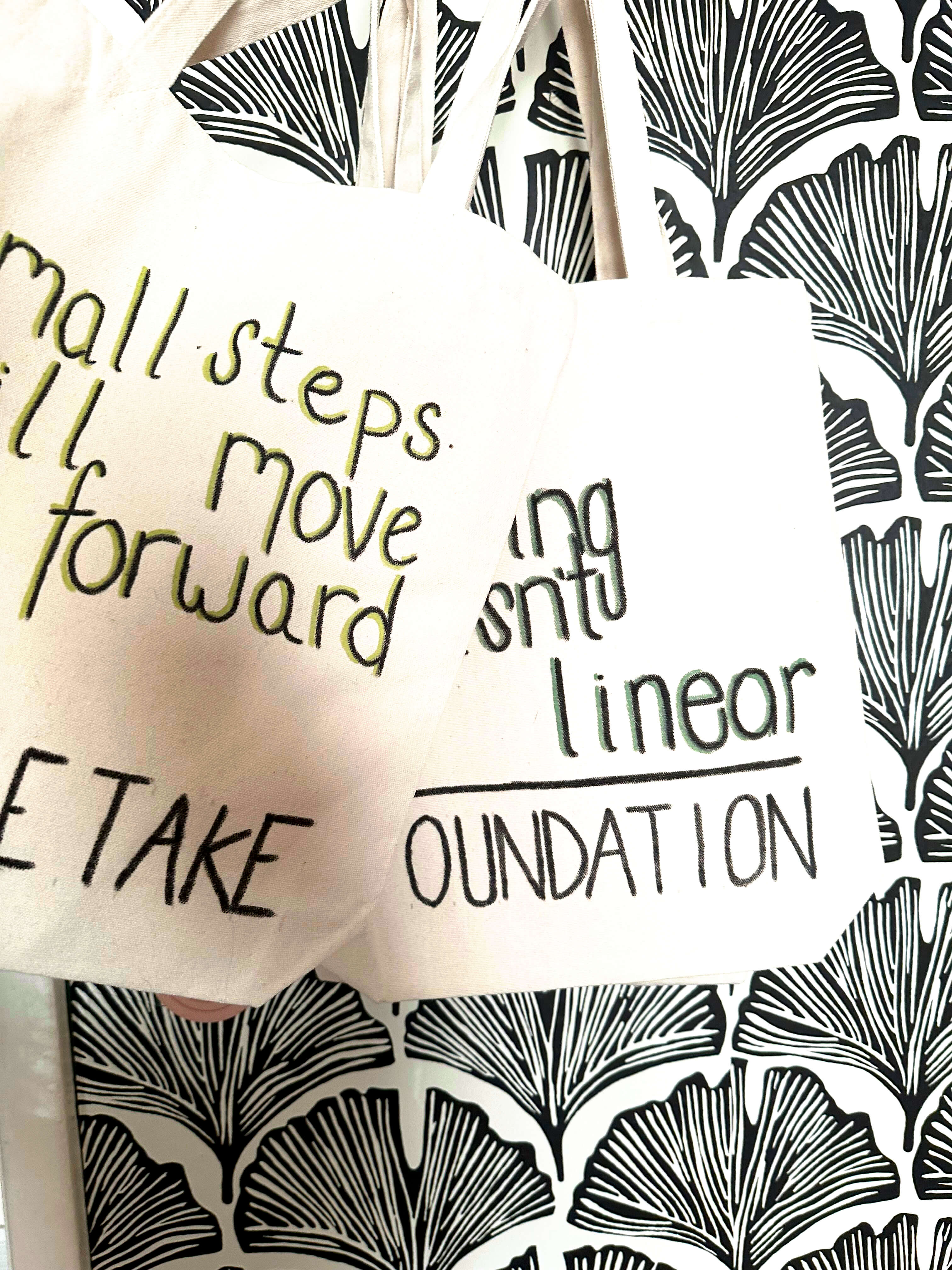 Tote bags with positive, motivational phrases on them. 